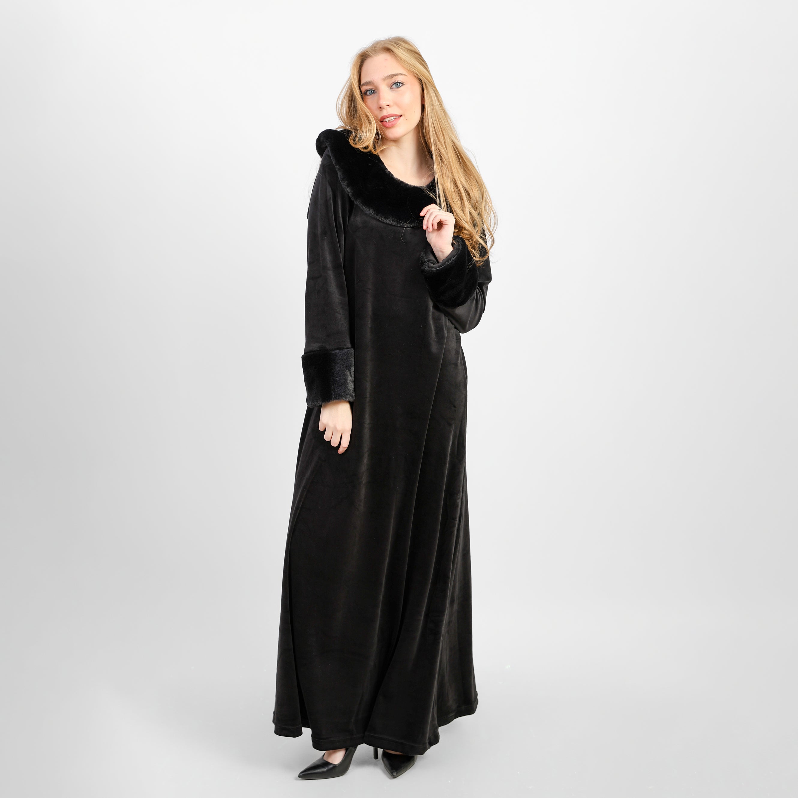 A winter velvet abaya in deep black, designed with a refined